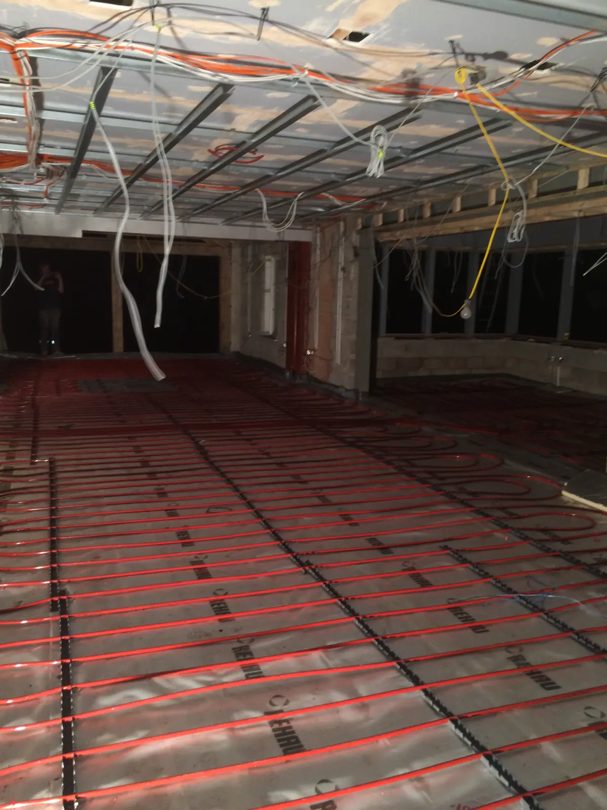 Underfloor heating pipe clipped to insulation boards